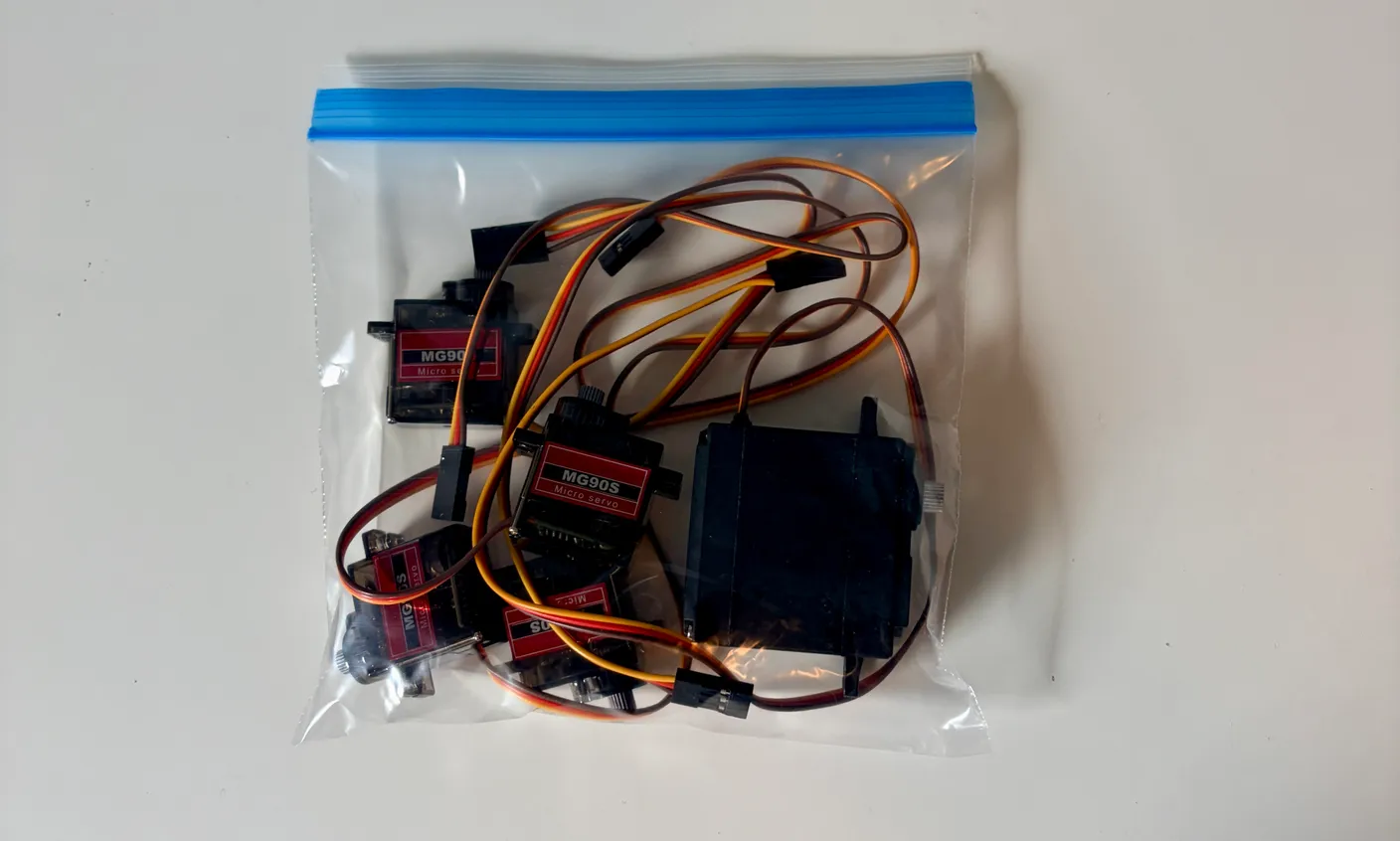 Robotic Arm build — Start with the Base: Take the little motors, called servos, out of their bags — four smaller ones and one larger one.