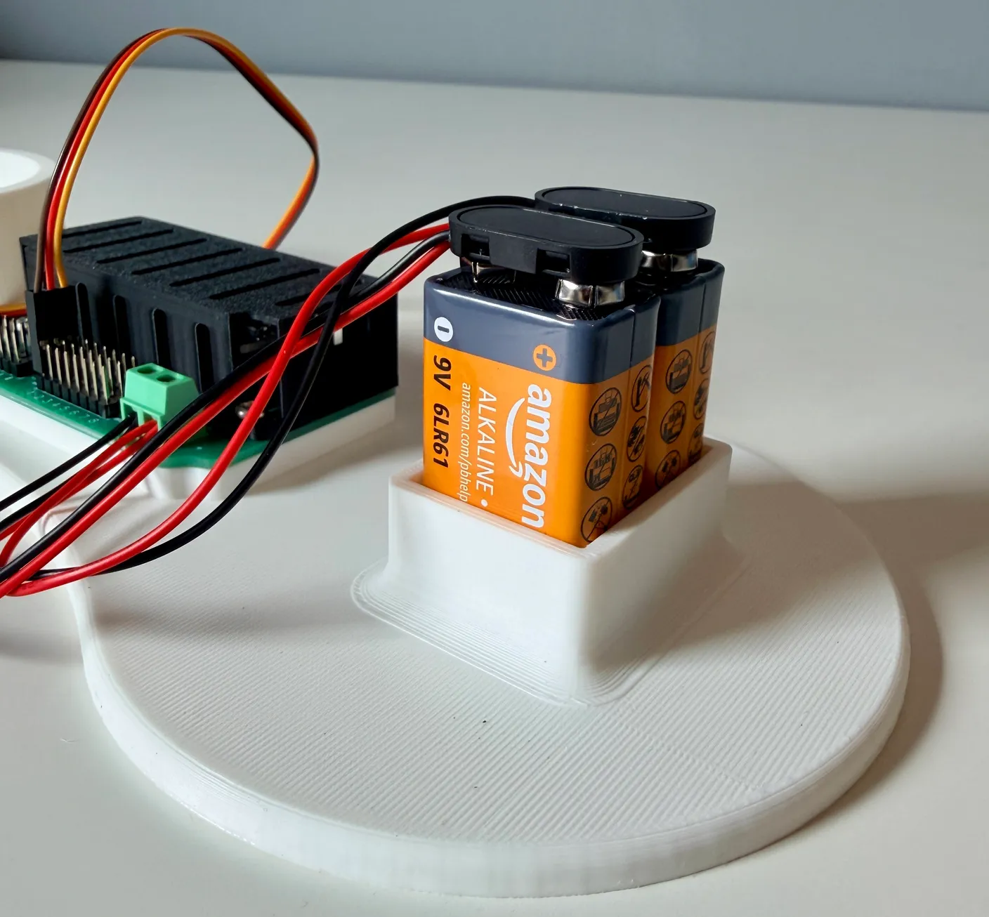Robotic Arm build — Start with the Base: Plug in the batteries.