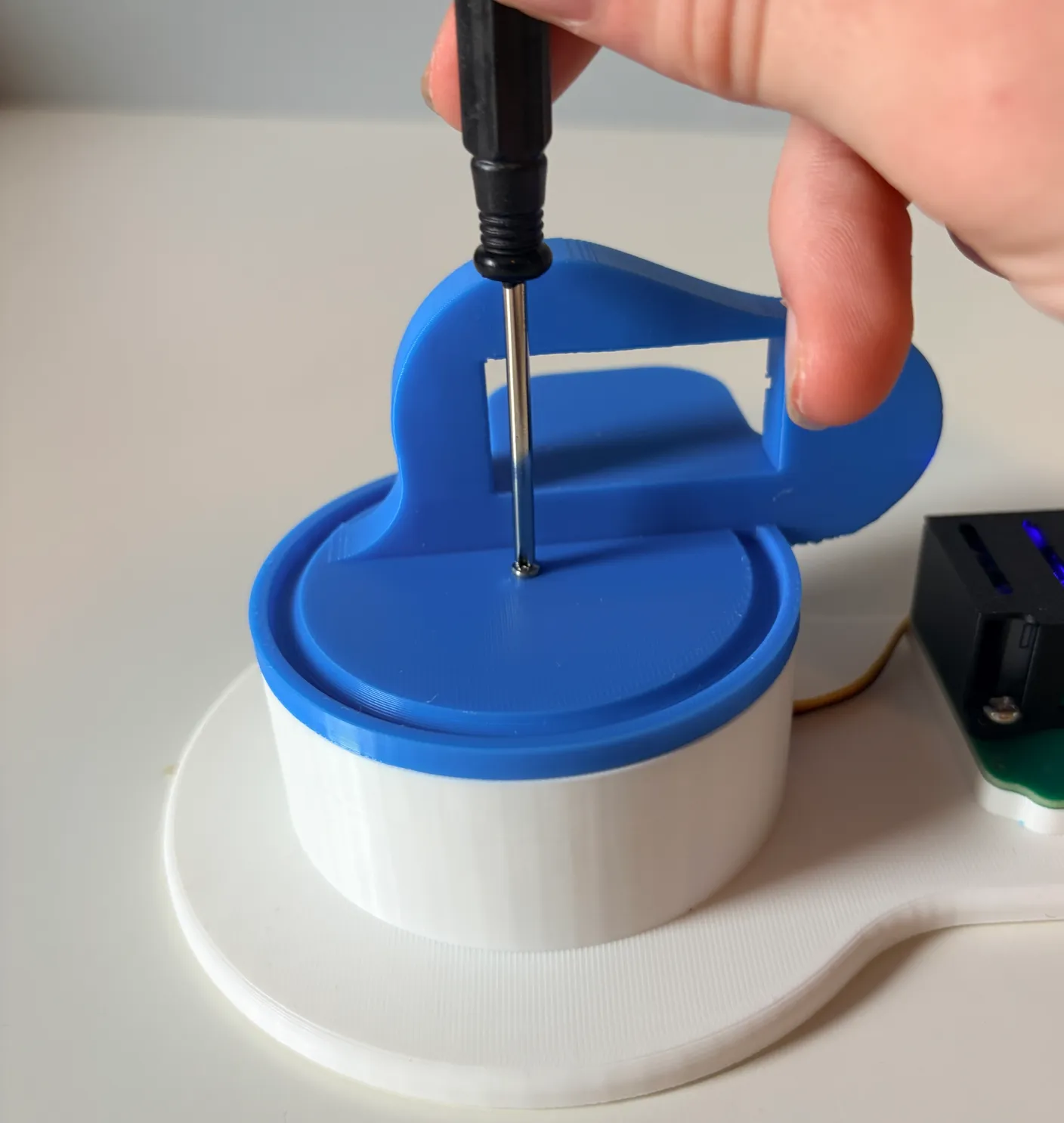Robotic Arm build — Assemble the First Half of the Arm: Screw the blue part in tight with a screw from the servo bag.