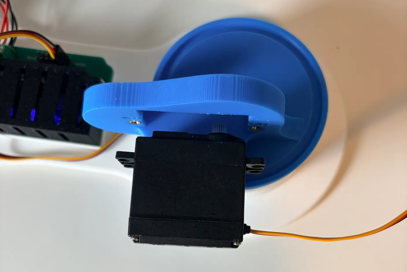 Robotic Arm build — Assemble the First Half of the Arm: Align the big servo with the wire facing away from the circuit board.