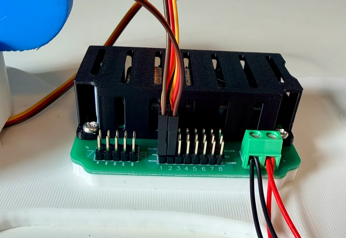 Robotic Arm build — Assemble the First Half of the Arm: Plug the motor into column 2, matching the wire colors to the board.