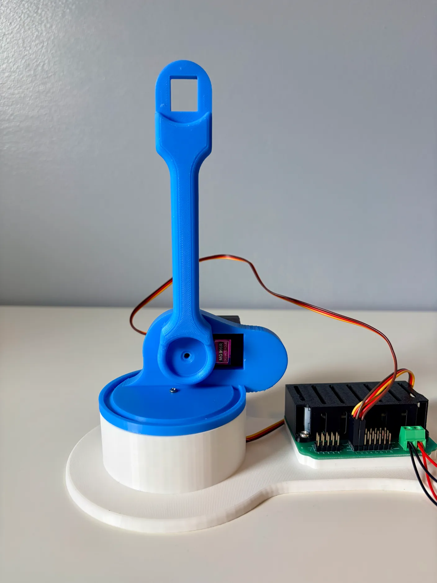 Robotic Arm build — Assemble the First Half of the Arm: Attach the arm to the big servo, pointing straight up at a 90-degree angle to the ground.