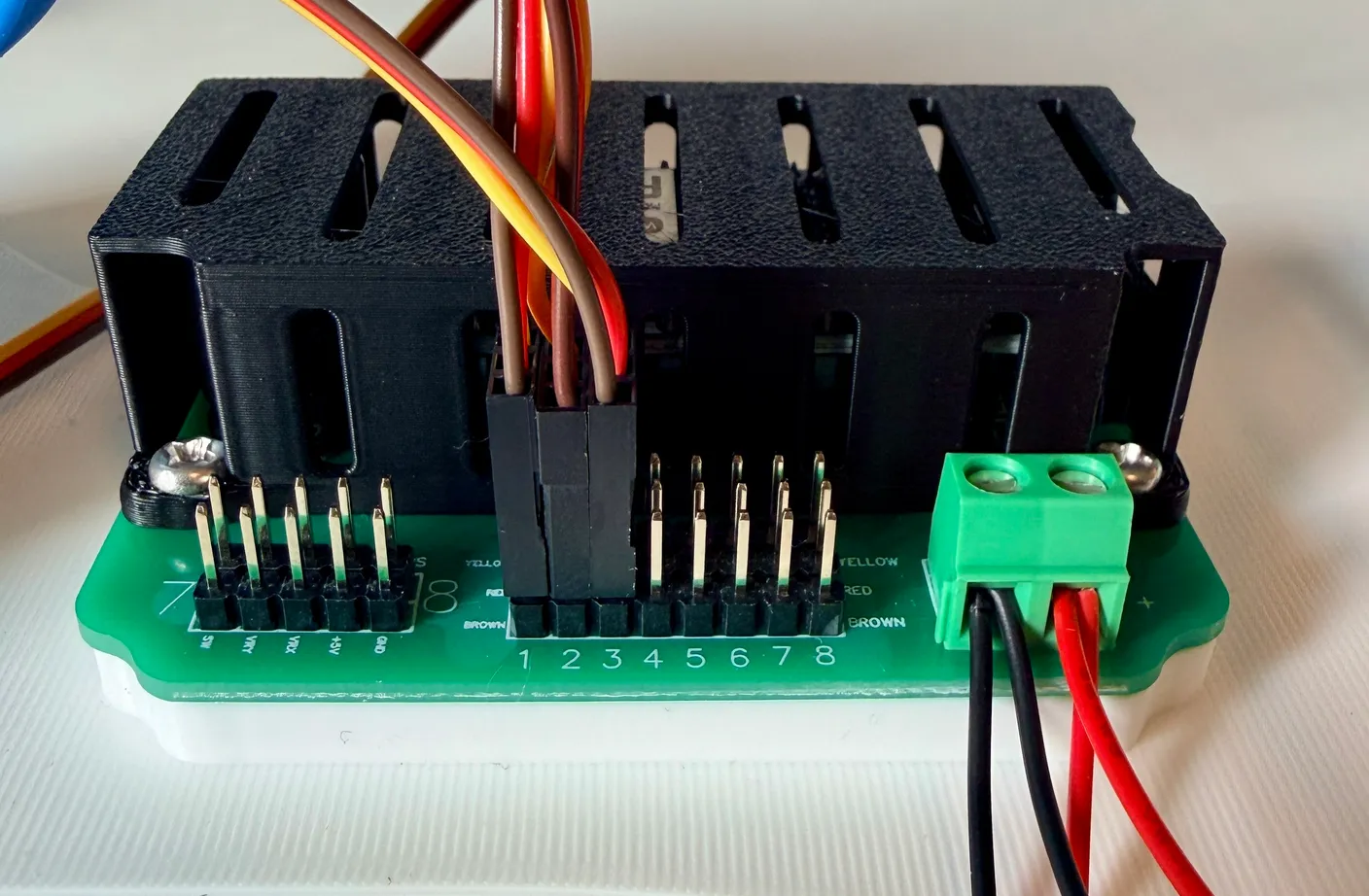 Robotic Arm build — Assemble the Other Half of the Arm: Plug this servo into column 3, yellow end toward the black box and brown end facing you.