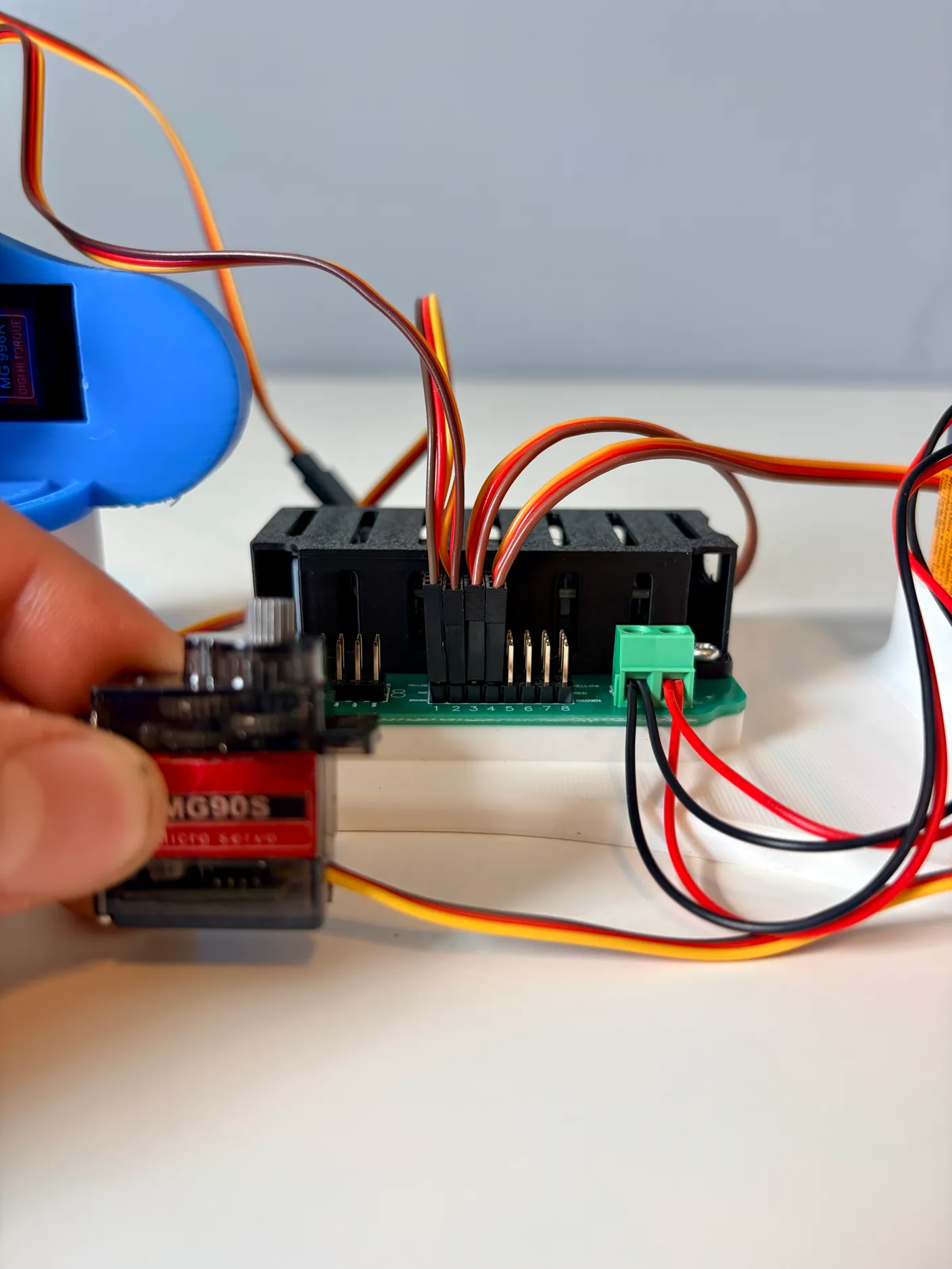 Robotic Arm build — Assemble the Other Half of the Arm: Plug that servo into the circuit board, in column 4.
