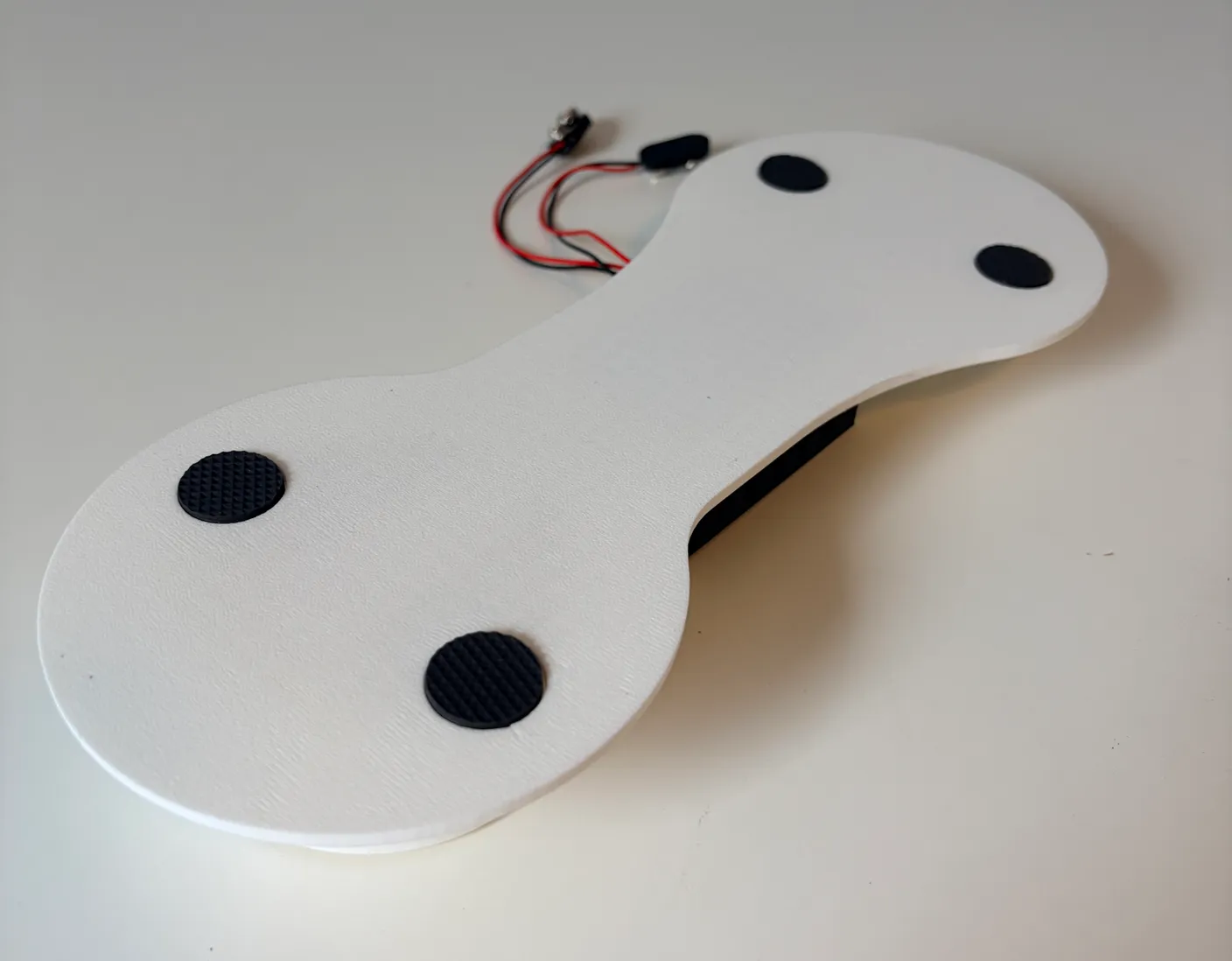 Robotic Arm build — Start with the Base: Stick the four rubber pads into the four slots on the bottom of the base.