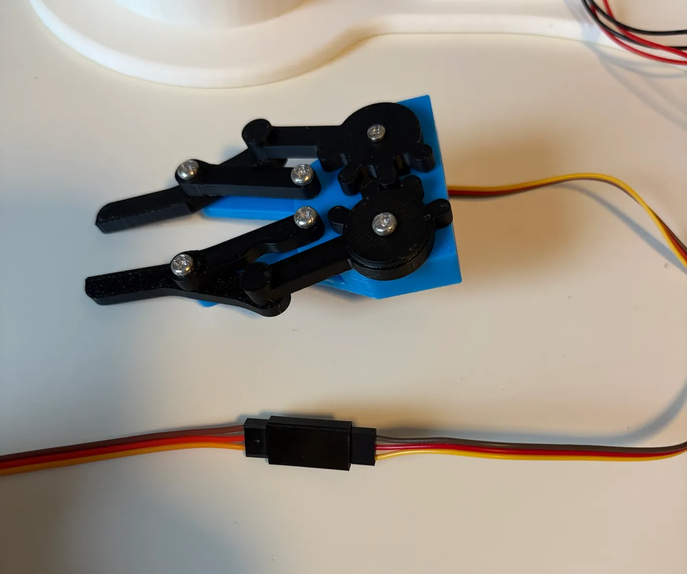 Robotic Arm build — Attach the Gripper: Connect the gripper’s servo wire to a servo wire extender, matching the colors.
