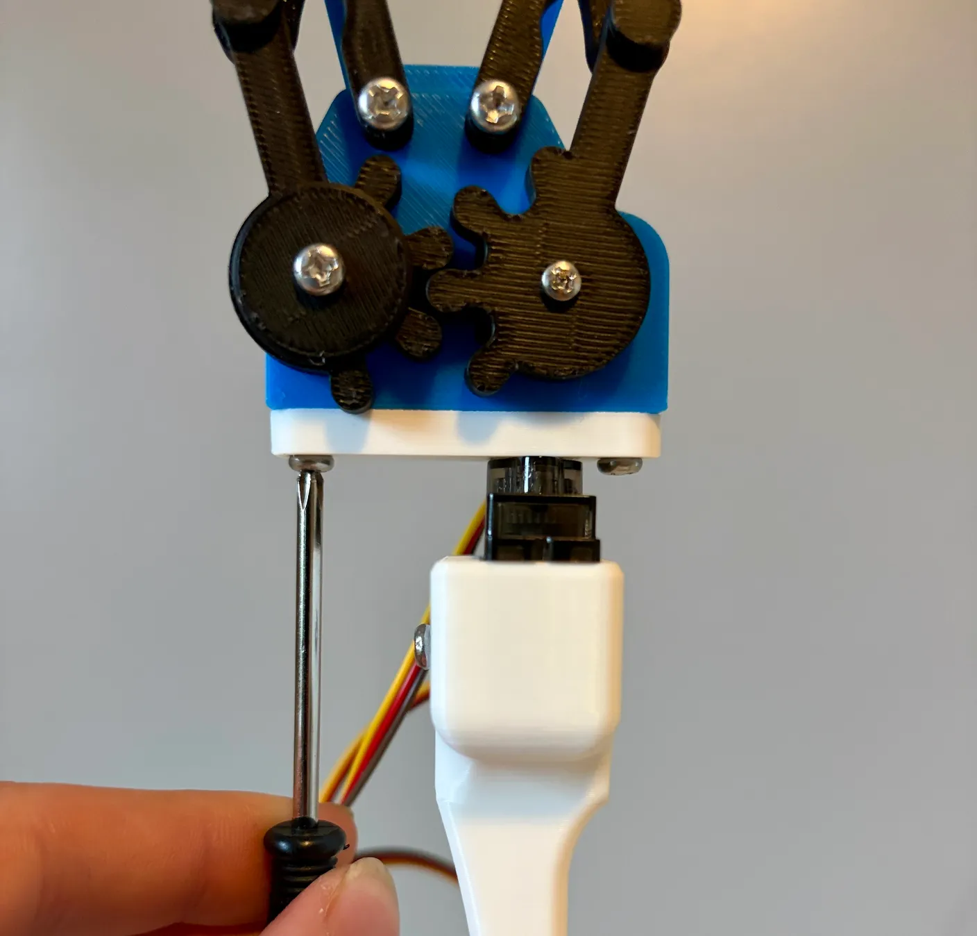 Robotic Arm build — Attach the Gripper: Attach the gripper to the wrist servo with two 10mm screws.