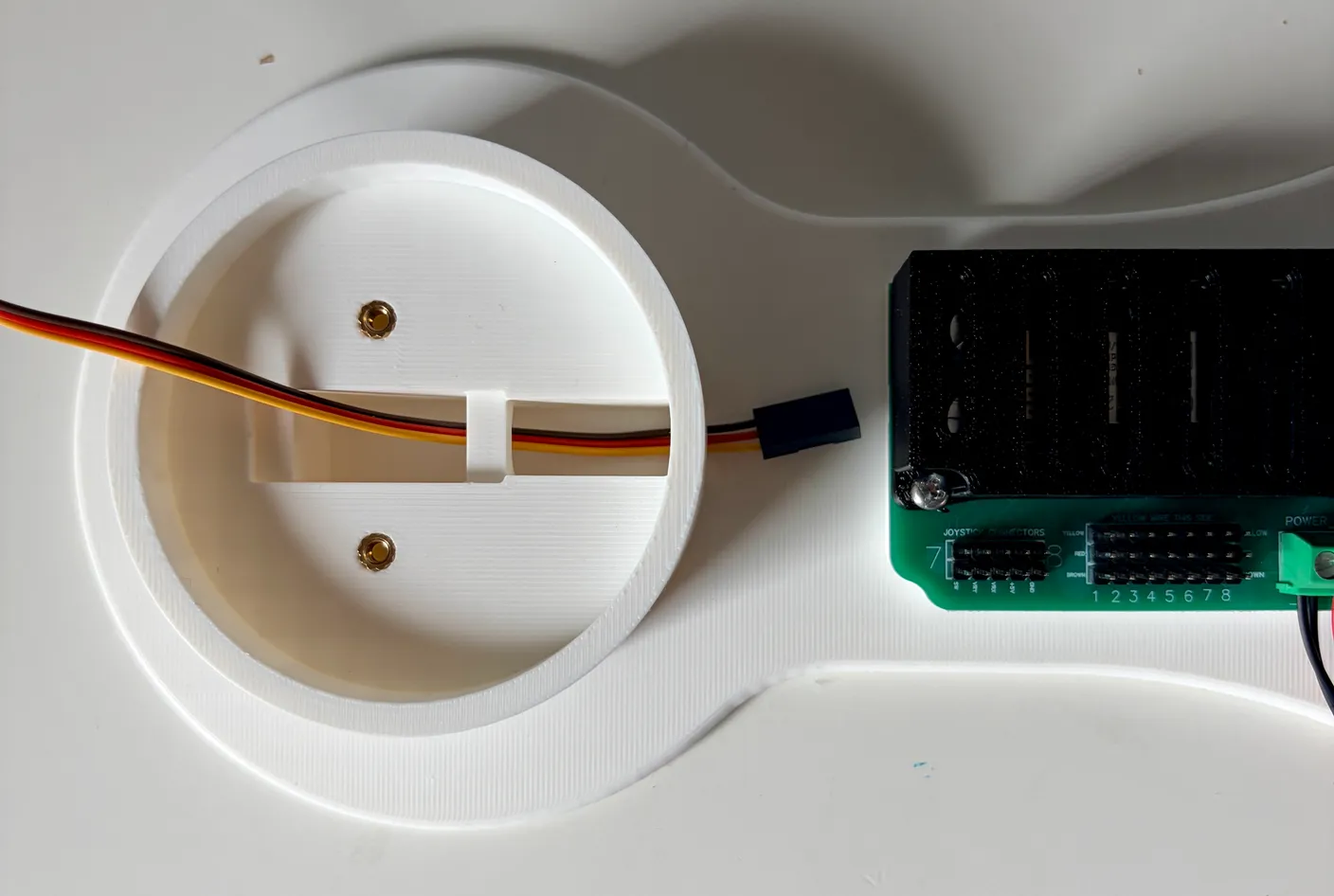 Robotic Arm build — Start with the Base: Fish the servo’s wire through the base.