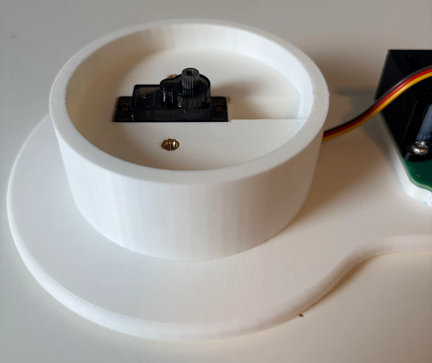 Robotic Arm build — Start with the Base: Once the wire is through, set the servo slowly into the slot so you don’t damage it.