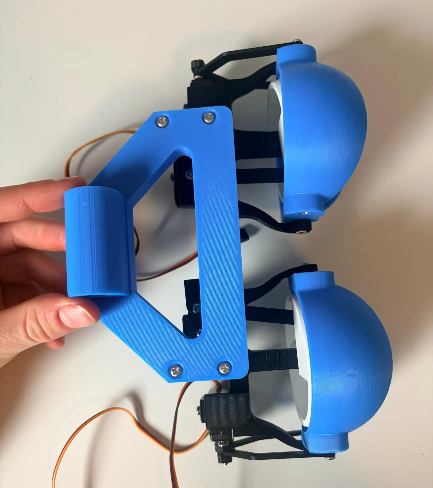 Robotic Eyes build — Assemble the Neck: Once they are in place, use four 12mm screws to tightly secure the eye mechanism to the neck base.