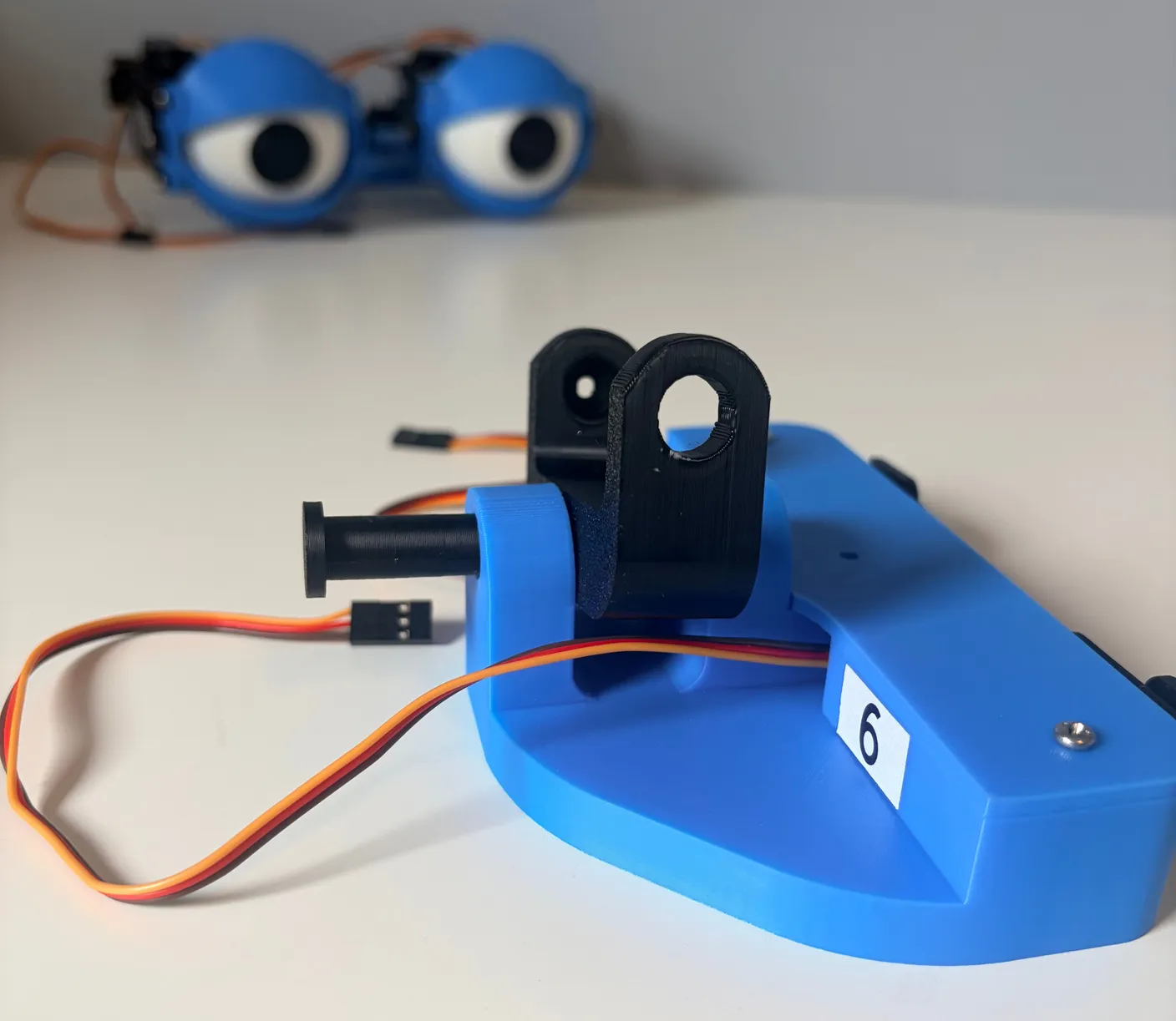 Robotic Eyes build — Assemble the Neck: Put the black joint into the base as shown below.