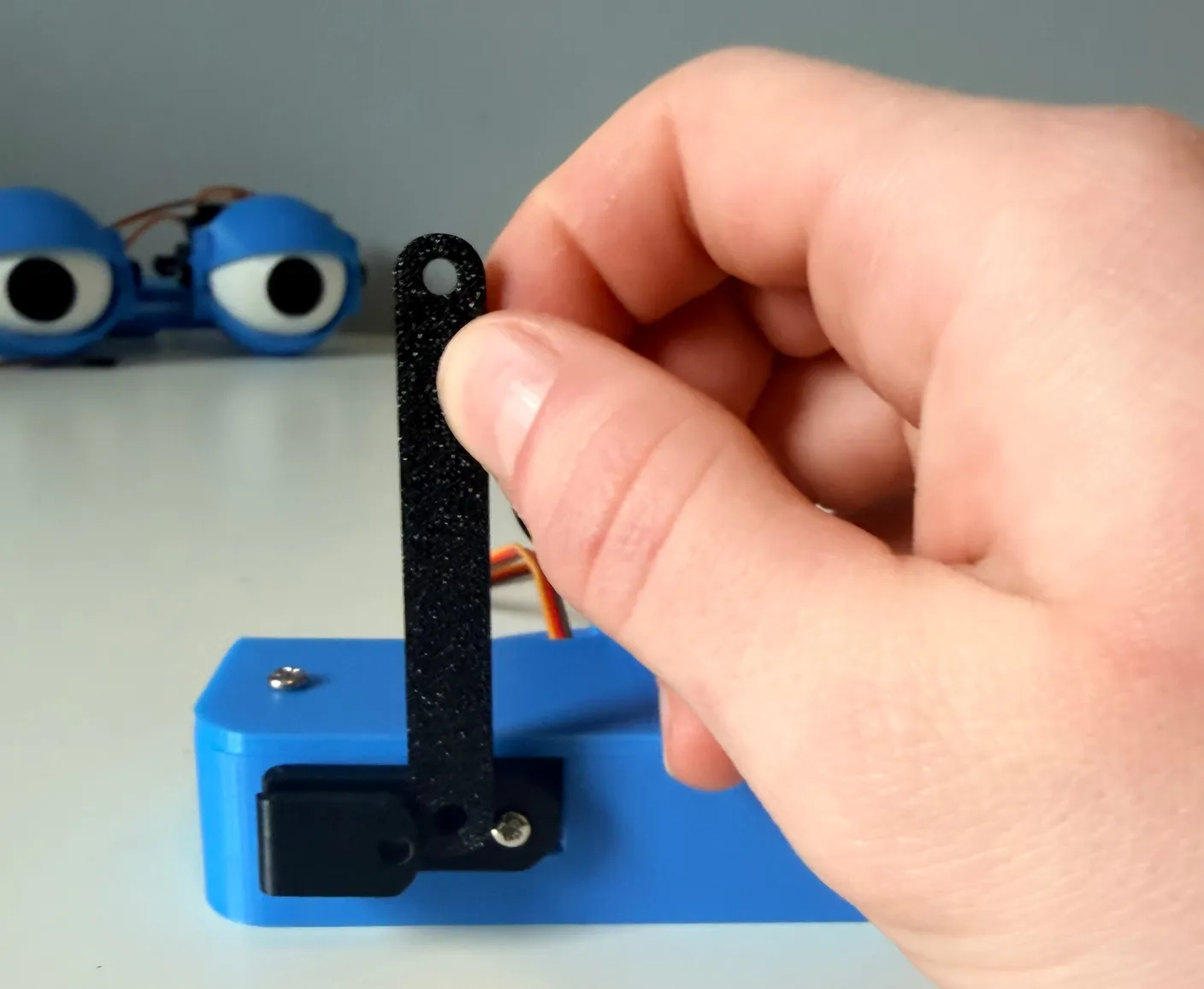 Robotic Eyes build — Assemble the Neck: Now, get the two black rods.
