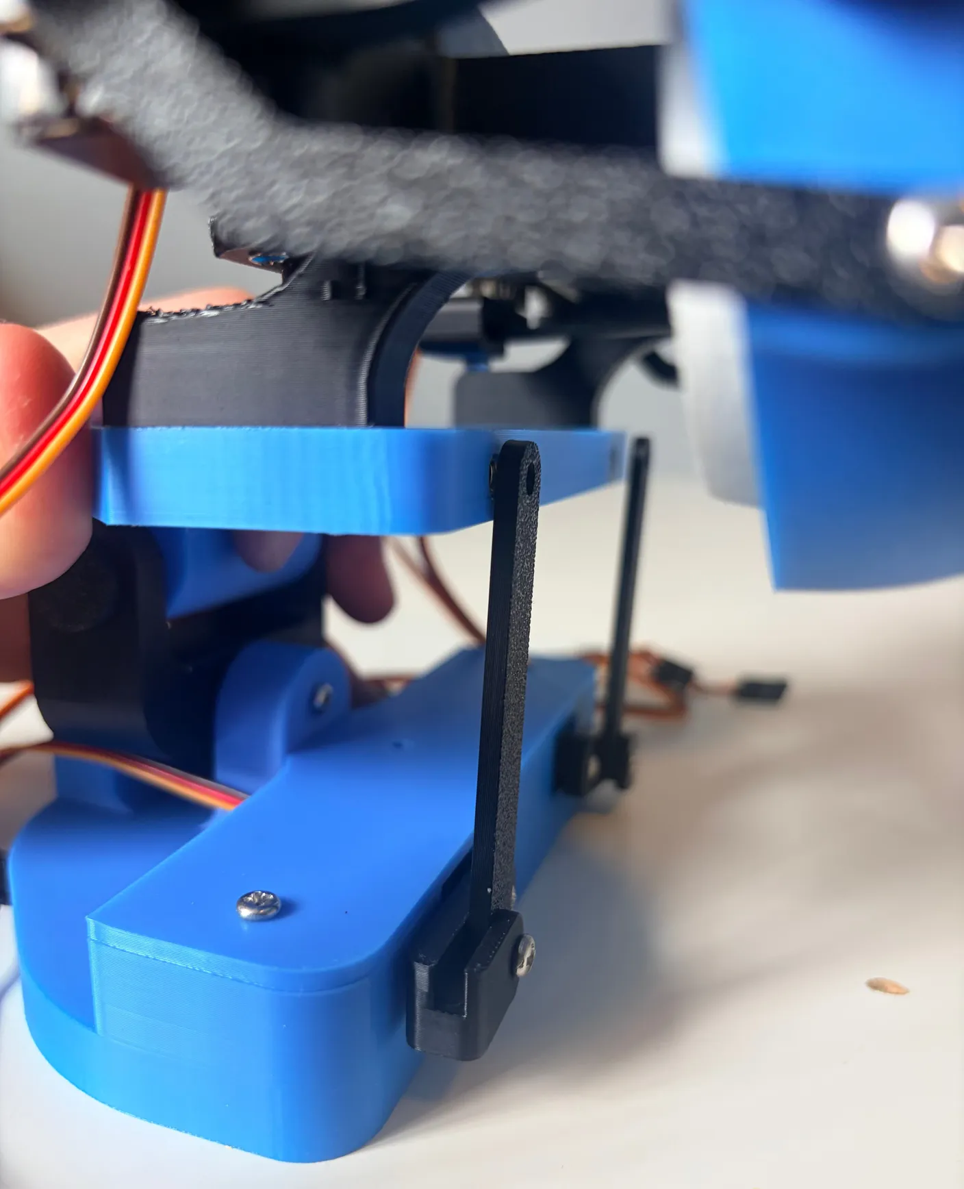 Robotic Eyes build — Assemble the Neck: Now we need to connect the rods that move it up and down to the actual eyes.
