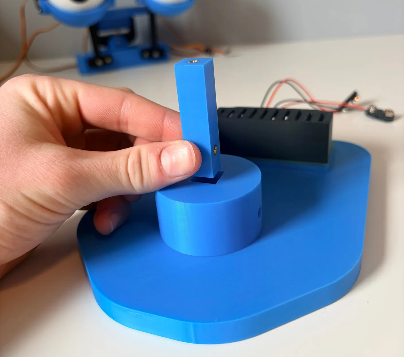 Robotic Eyes build — Assemble the Base: Now, flip the base back over and find the square pin.