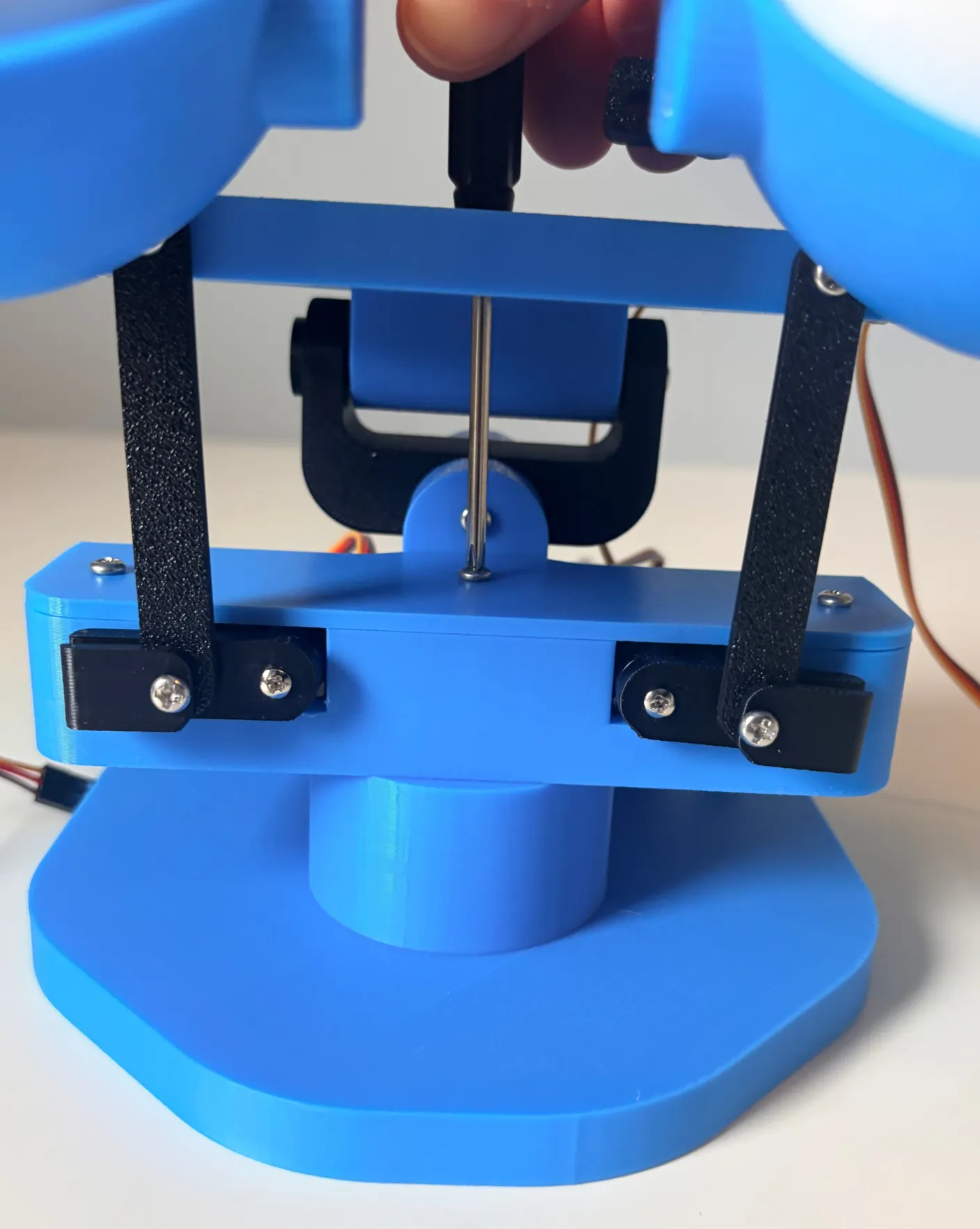 Robotic Eyes build — Assemble the Base: Put it on the pin, then use another 6mm screw to tighten them together.