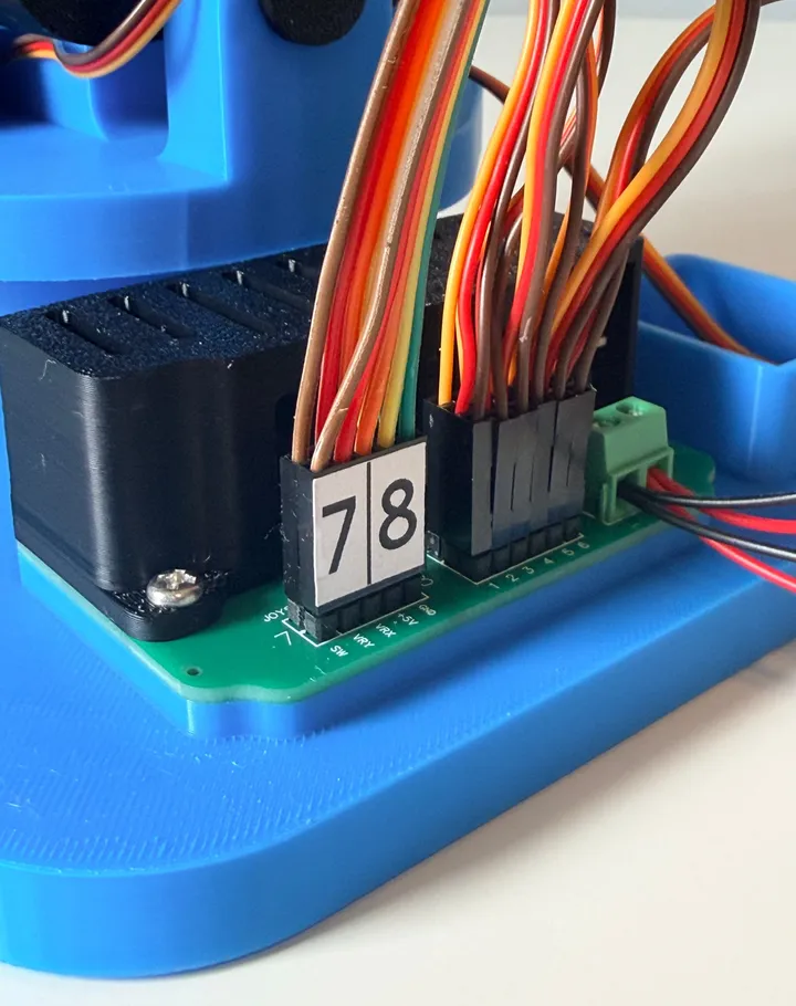 Close-up of the Robotic Eyes Kit's labeled control board wiring during assembly