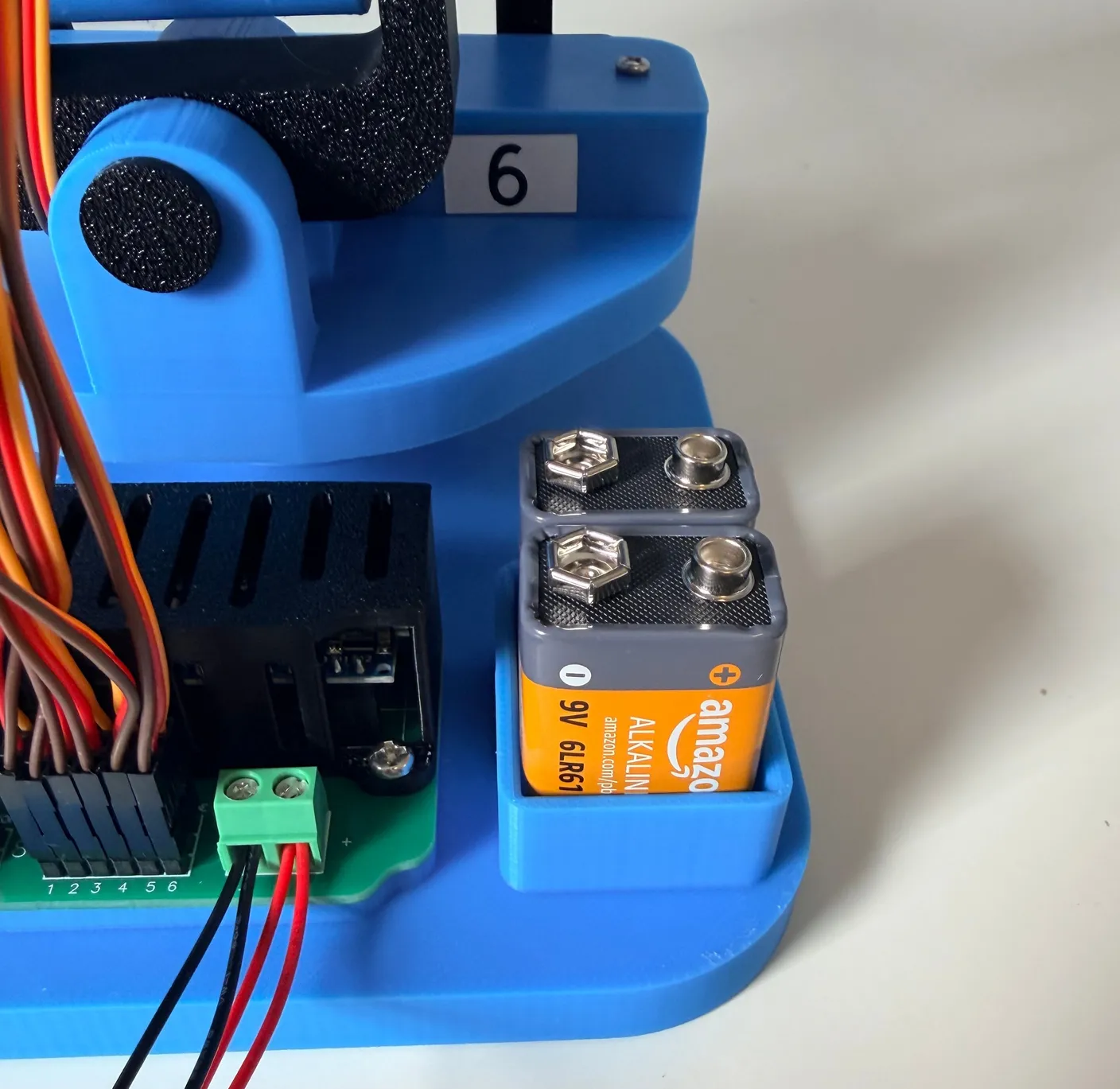 Robotic Eyes build — Wire it up: Unpack the two 9V batteries and put them in their slots, as shown below.