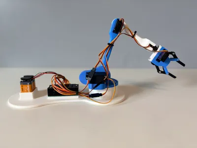 Robotic Arm Kit extended low and forward across the desk, showing its horizontal reach