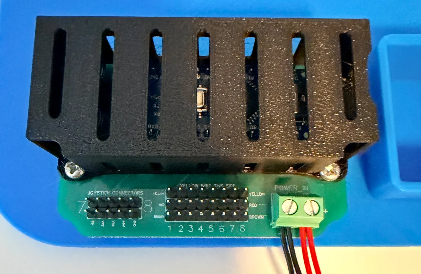 Robotic Eyes build — Wire it up: The circuit board, with the numbered servo pins and the “Yellow wires this side” label.