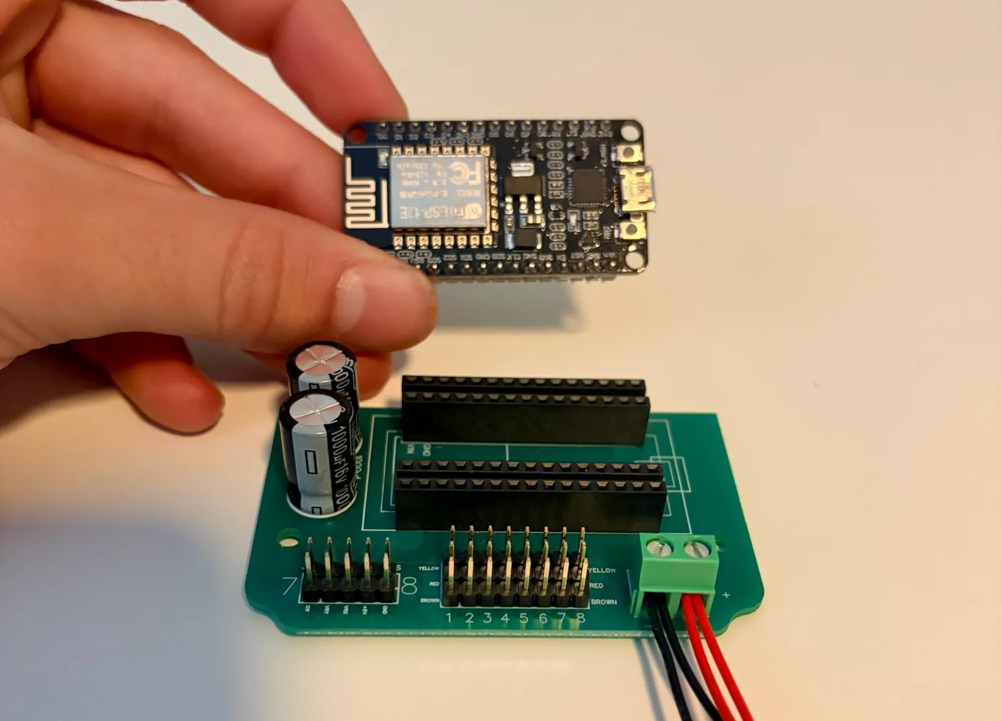 Robotic Eyes build — Swap from Joystick to Wireless: The wireless board lined up above the empty sockets.